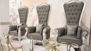 A luxurious seating area with ornate, tufted chairs and a matching sofa, set against a marble floor. - Green Rose Hotel (Batam)