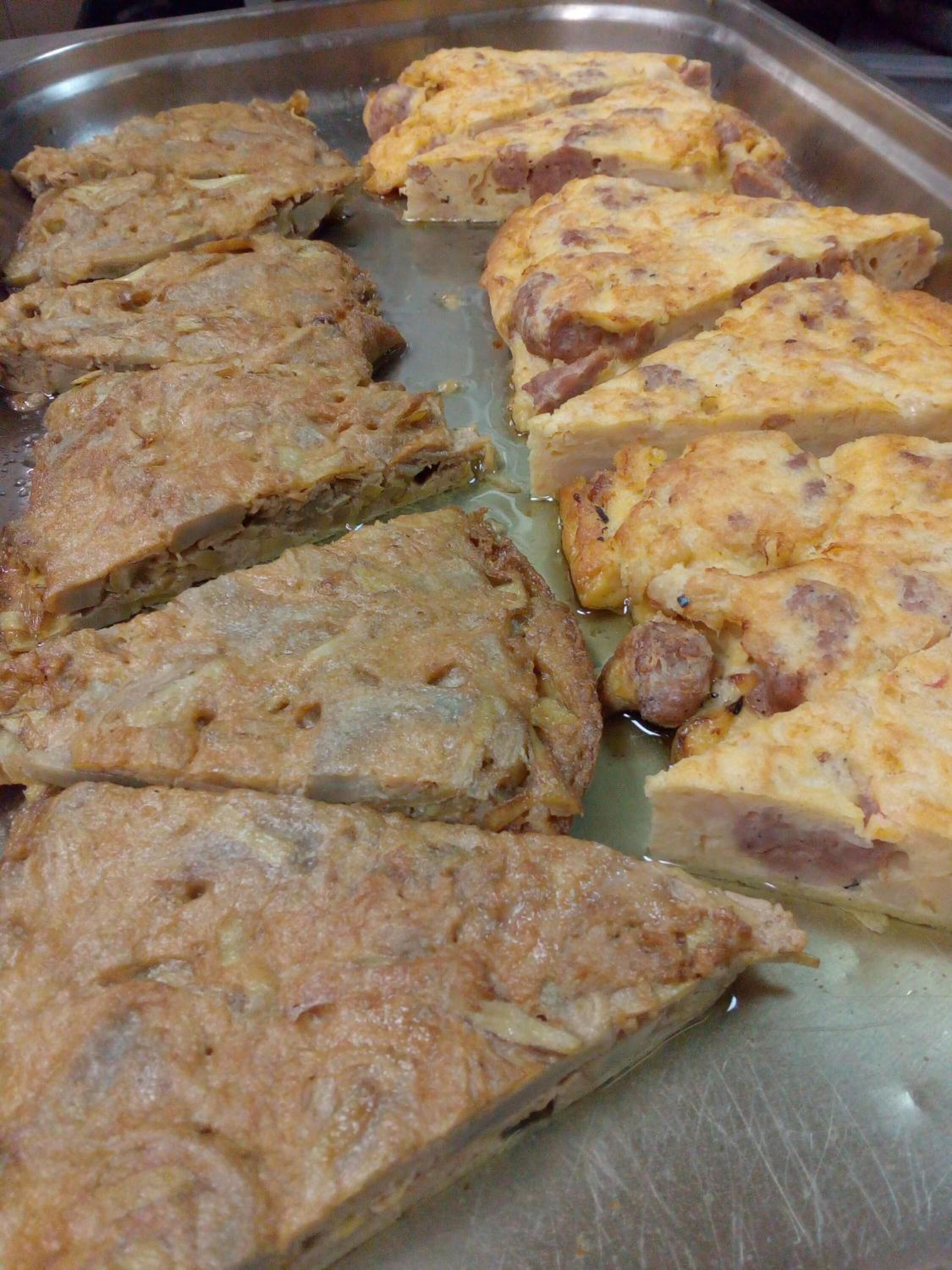 A tray of baked dishes, possibly quiches or savory pies, with a golden-brown crust.