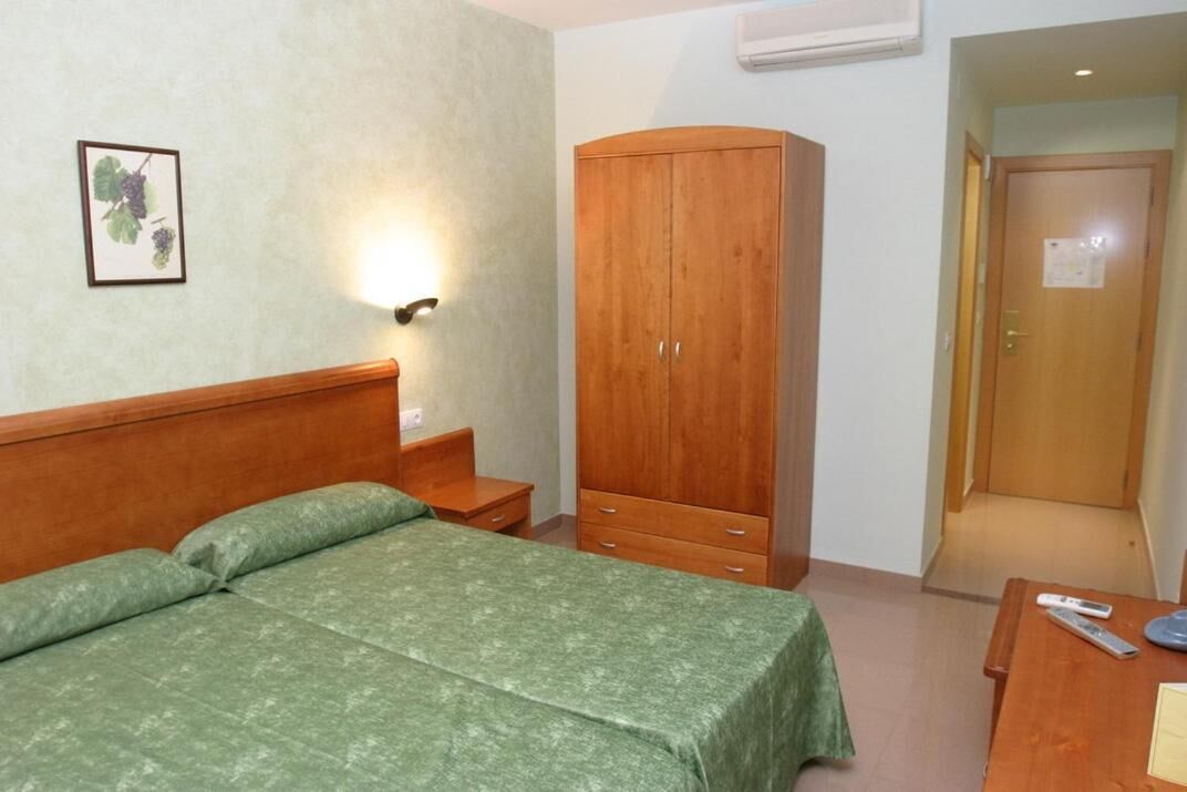 hypo-allergenic bedding, desk, laptop workspace, blackout curtains