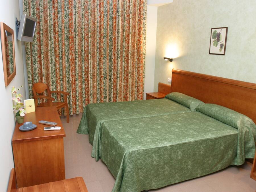 Hypo-allergenic bedding, desk, laptop workspace, blackout curtains