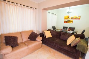 Luxury Apartment, 1 Bedroom, City View | Living room | 50-inch flat-screen TV with cable channels, TV, DVD player - The Bailey's New Kingston Suites (Kingston)