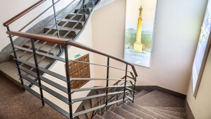 A staircase with metal railings and carpeted steps. - Veneti Suites (Belgrade)