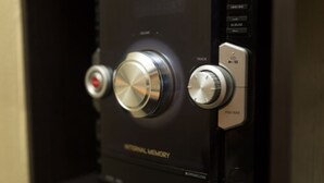 A control panel with buttons labeled "TRACK," "CD," and "FM/AM." - New Kingston Most Central Guest Apt (Kingston)
