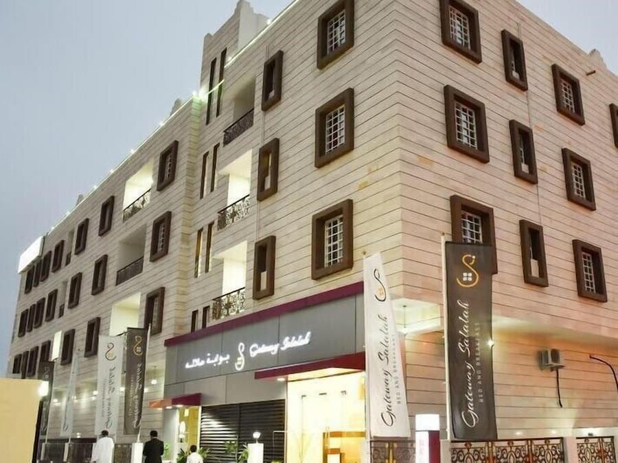A multi-story hotel with a modern facade, featuring a prominent entrance with a sign for a restaurant and a spa.