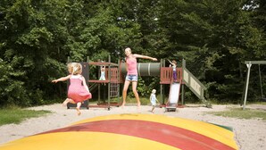 A playground with a slide and climbing structures.