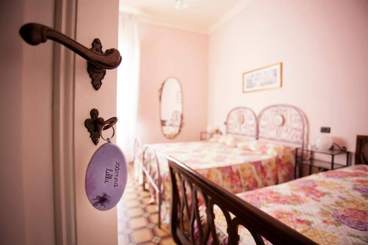 A bedroom with a bed, a dresser, and a mirror on the wall.