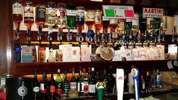 A bar with various liquor bottles and a sign indicating house spirits. - Channel View Hotel (Sandown)
