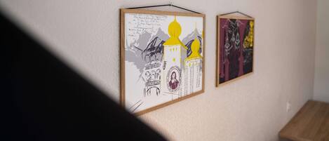 Two framed artworks on a wall.