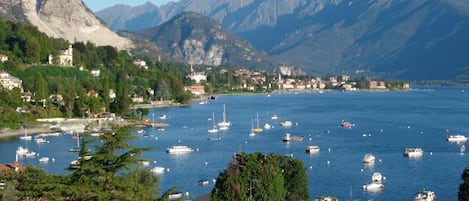 A coastal town with a marina filled with boats, surrounded by mountains.