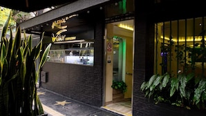 A restaurant with a sign reading "Veler Restaurant" and a visible entrance. - Hotel Veler (Medellín)