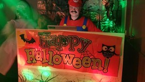 A Halloween-themed display with a sign that reads 'Happy Halloween!'