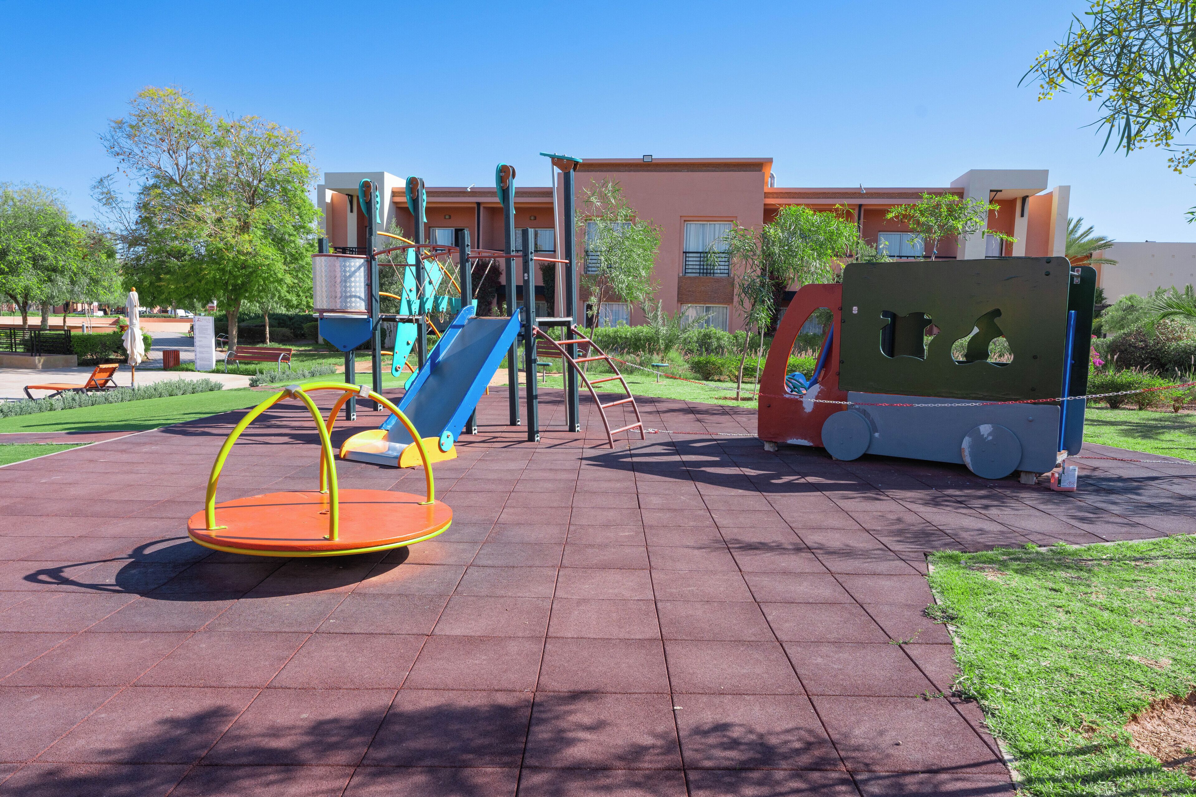 A playground with swings, slides, and climbing structures.
