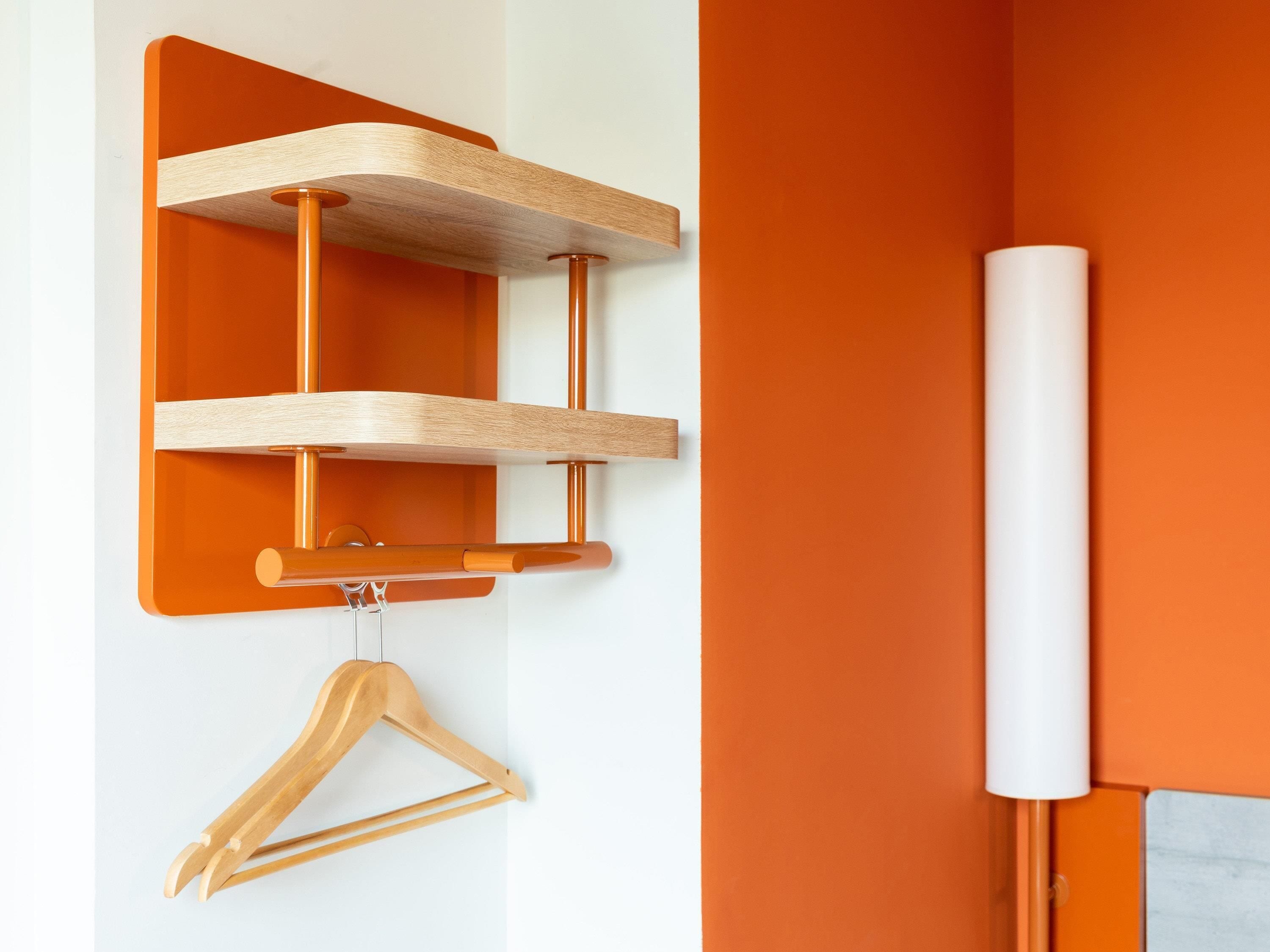 Een houten wandplank met een houten kapstok.