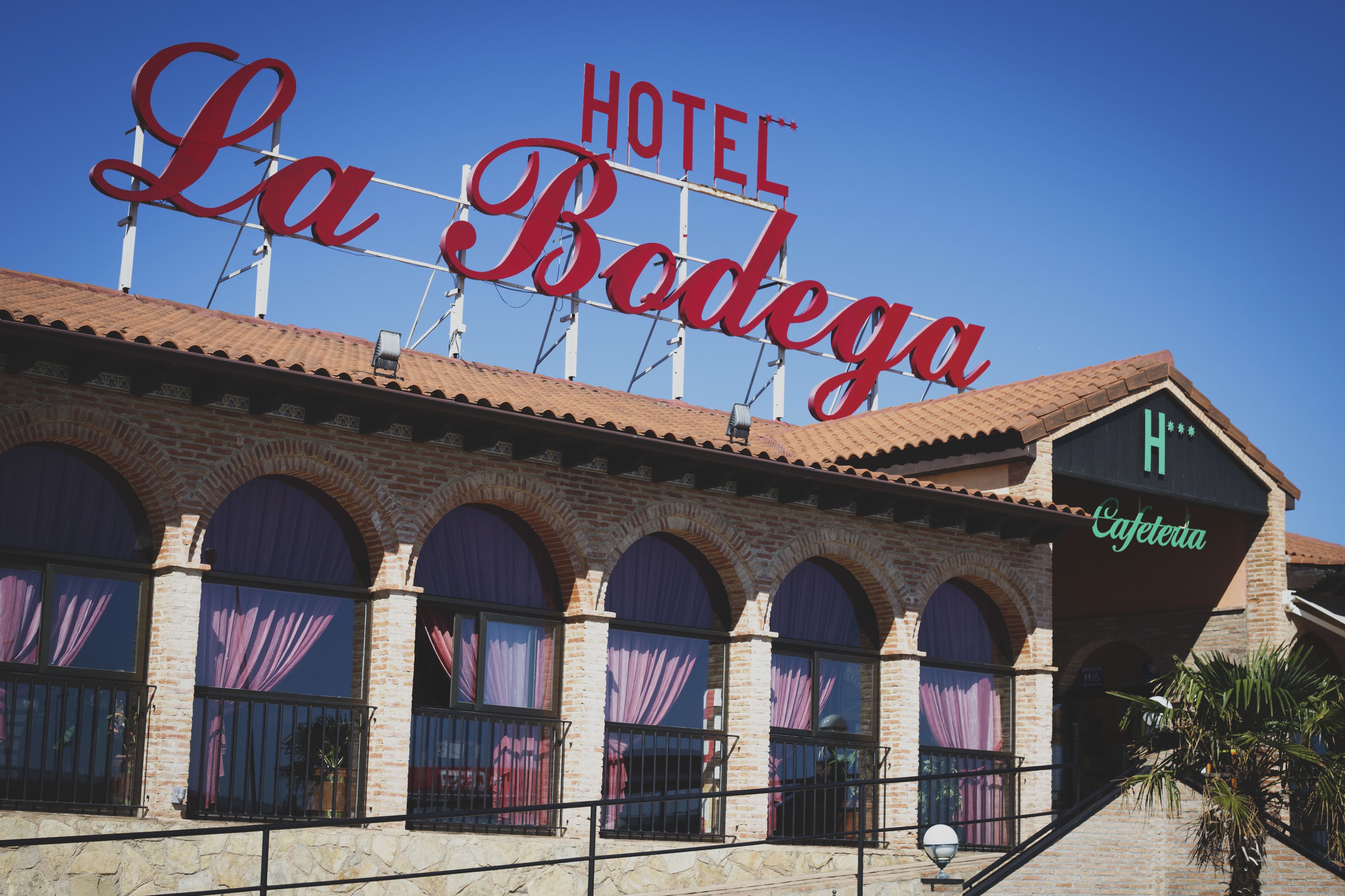 A hotel named "La Bodega" with a prominent sign, arched windows, and a visible entrance.