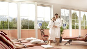 A spa area with multiple sun loungers, a massage chair, and a view of the outdoors. - Sporthotel Zum Hohen Eimberg (Willingen)