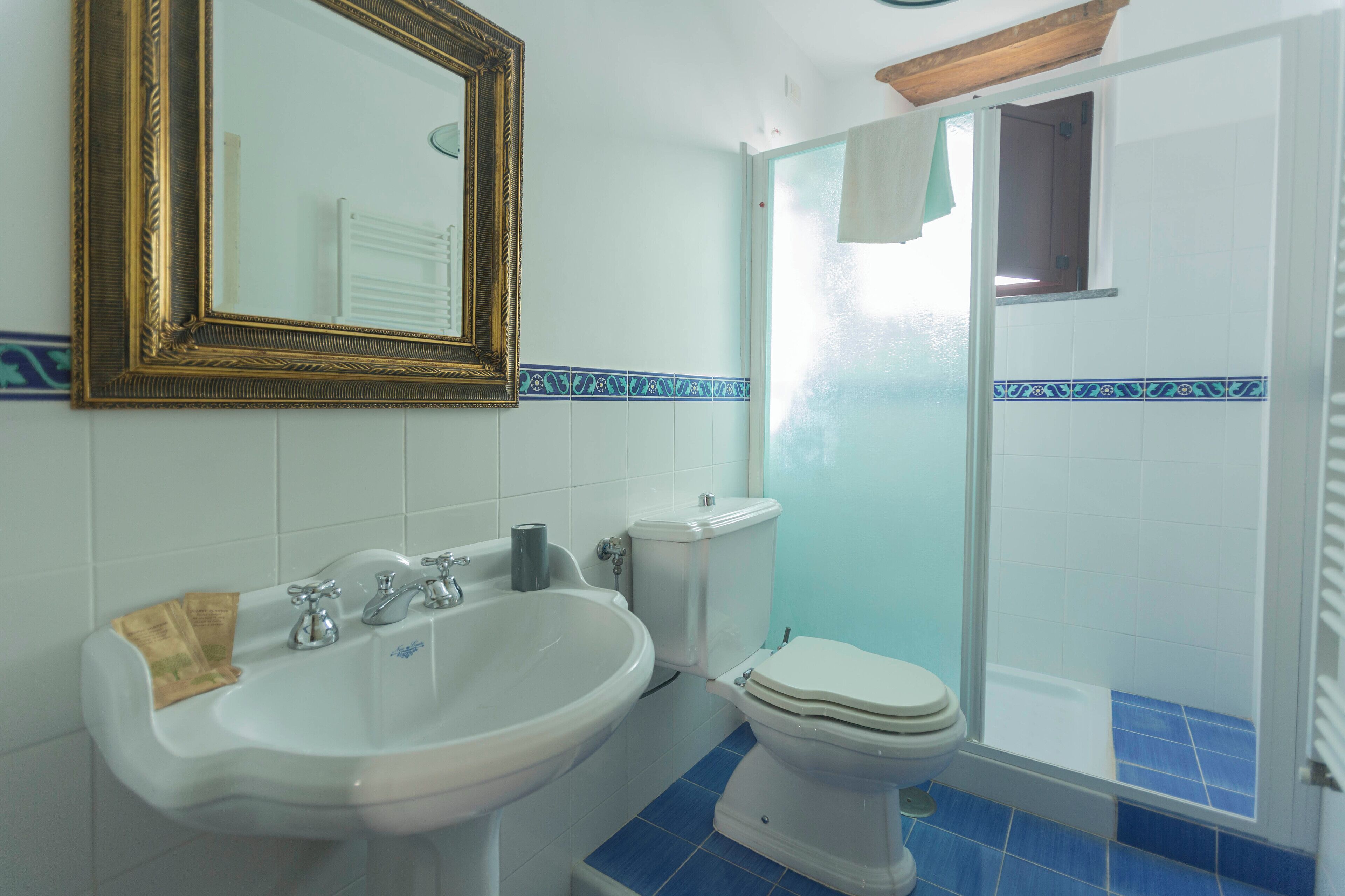 A bathroom with a sink, toilet, and shower.