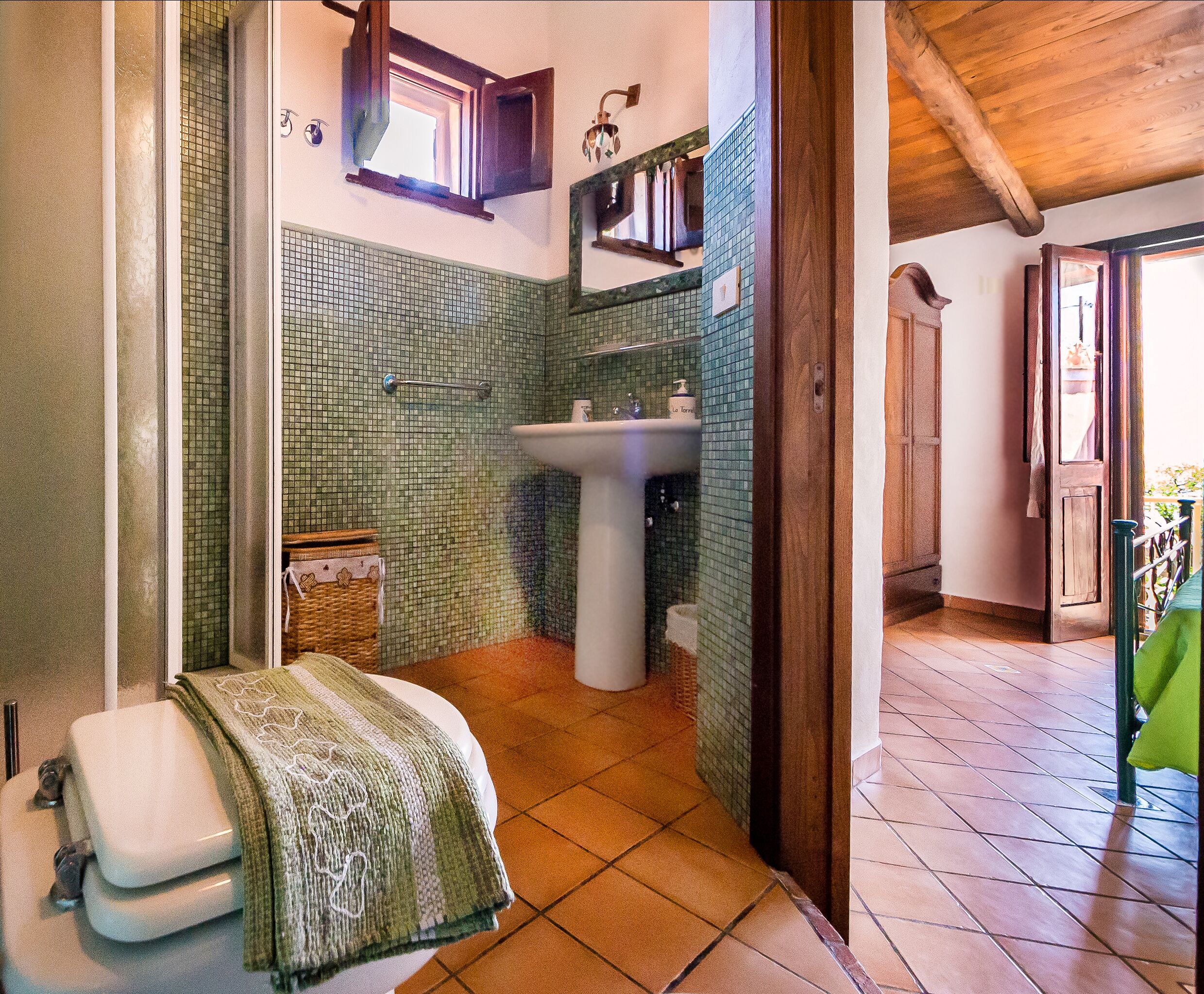 Un baño con piso de baldosas, un lavamanos y una ventana.