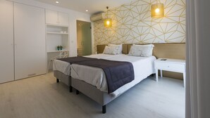 A modern bedroom with a bed, bedside tables, a wardrobe, and geometric wall design.