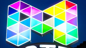 A hotel sign with a colorful geometric logo and the word "HOTEL" below it.