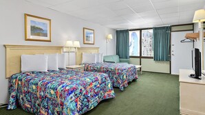 A hotel room with two beds, a desk, a chair, a TV, and a window with curtains. - Surf Inn Suites (Ocean City)