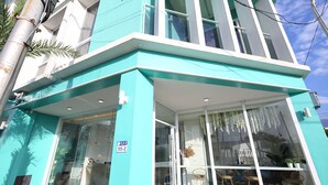 A modern building with a teal facade, large windows, and a visible entrance. - Blue Ocean BnB (Hualien City)
