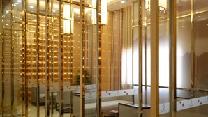 A modern hotel lobby with glass partitions, seating areas, and a decorative wall. - Shanshui S Hotel Maliandao (Beijing)