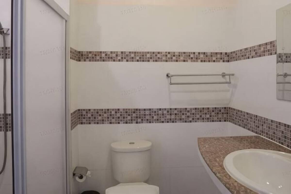 A bathroom with a toilet, bidet, and sink.