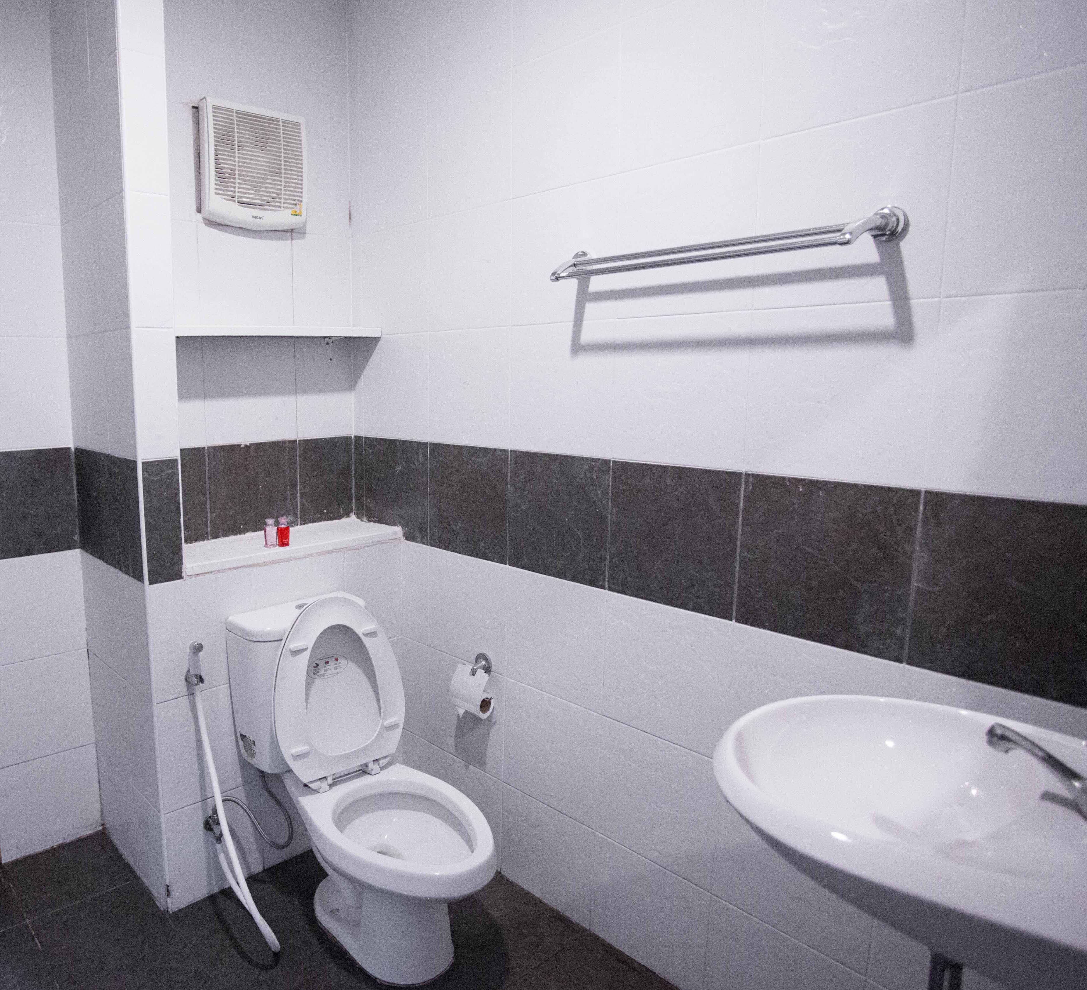 A modern bathroom with a toilet, bidet, and sink.