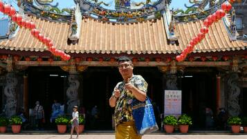 A traditional Chinese building with ornate architecture, including a dragon motif on the roof.