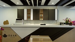 A modern kitchen with built-in cabinets, a coffee machine, and a sink.