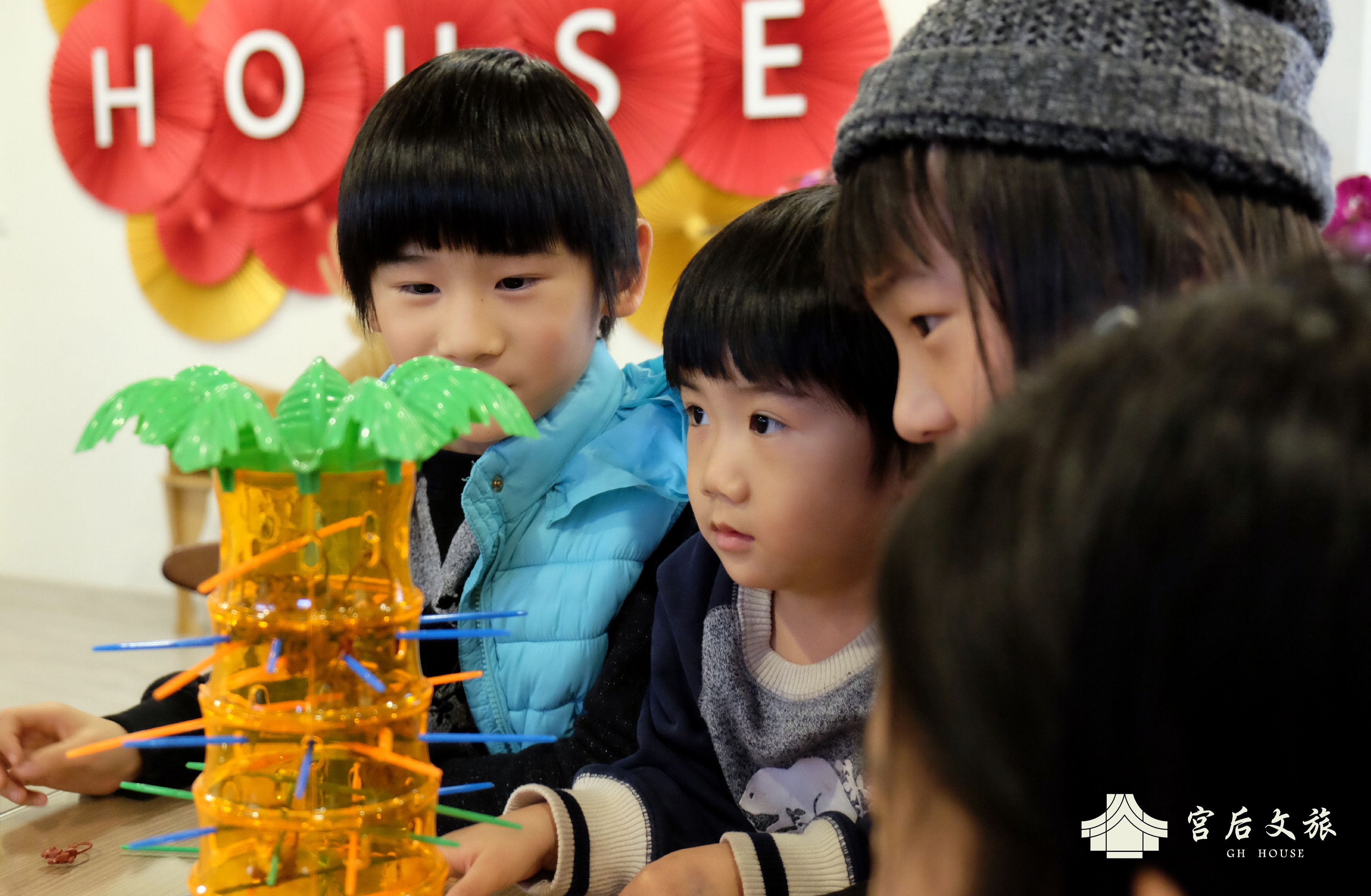 A group of people engaged in a craft activity with a colorful structure.