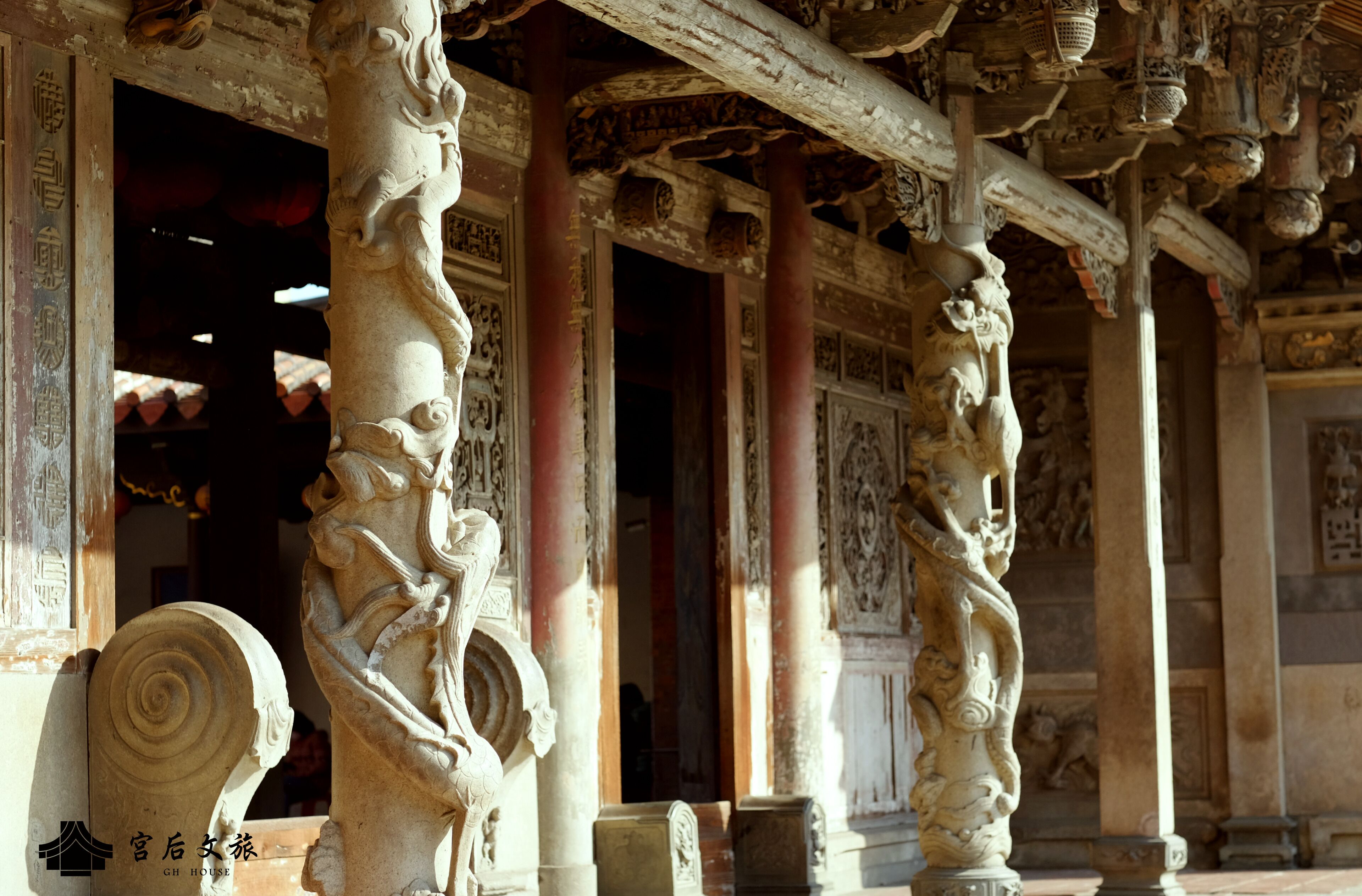 A detailed architectural structure with ornate carvings and columns, likely part of a historical building.