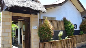 A building with a thatched roof entrance labeled "Meisya Cottage." - Meisya Cottage (Gili Trawangan)