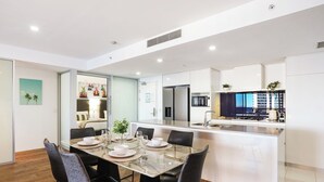 A modern kitchen with white cabinets, a built-in microwave, and a gas stove.