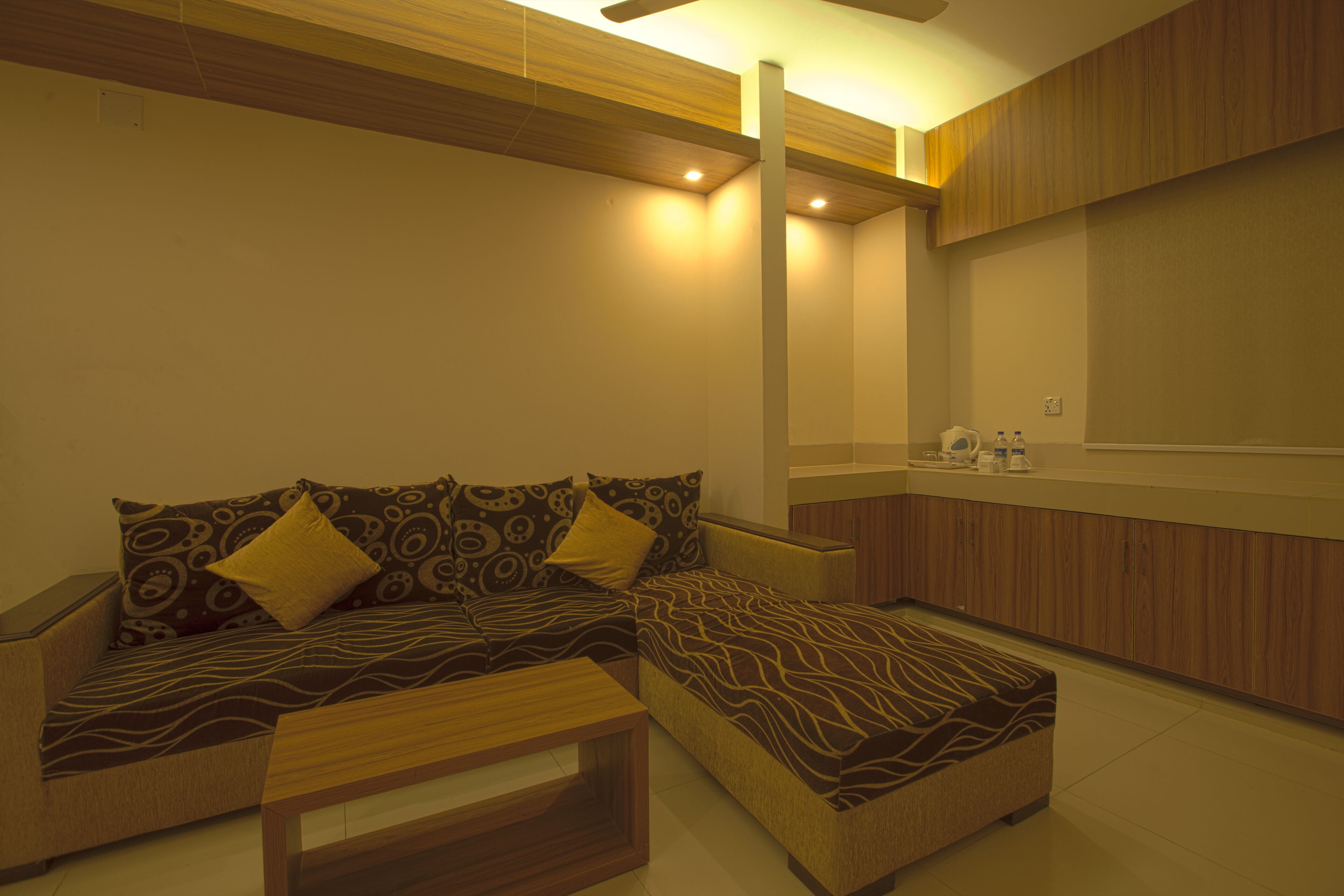 A modern living room with a sofa, ottoman, and coffee table.