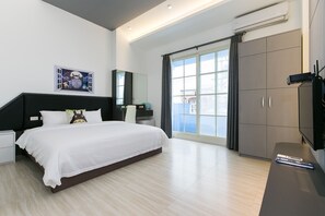 A modern bedroom with a large bed, a nightstand, a dresser, and a TV. - Together B&B (Sanxing)