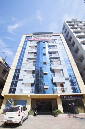 A multi-story hotel with a prominent sign reading "HOTEL BAY MARINA".