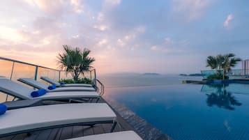 Outdoor pool, open 10:00 AM to 6:00 PM, pool umbrellas, pool loungers