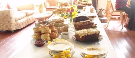 A buffet table with various baked goods and pastries.