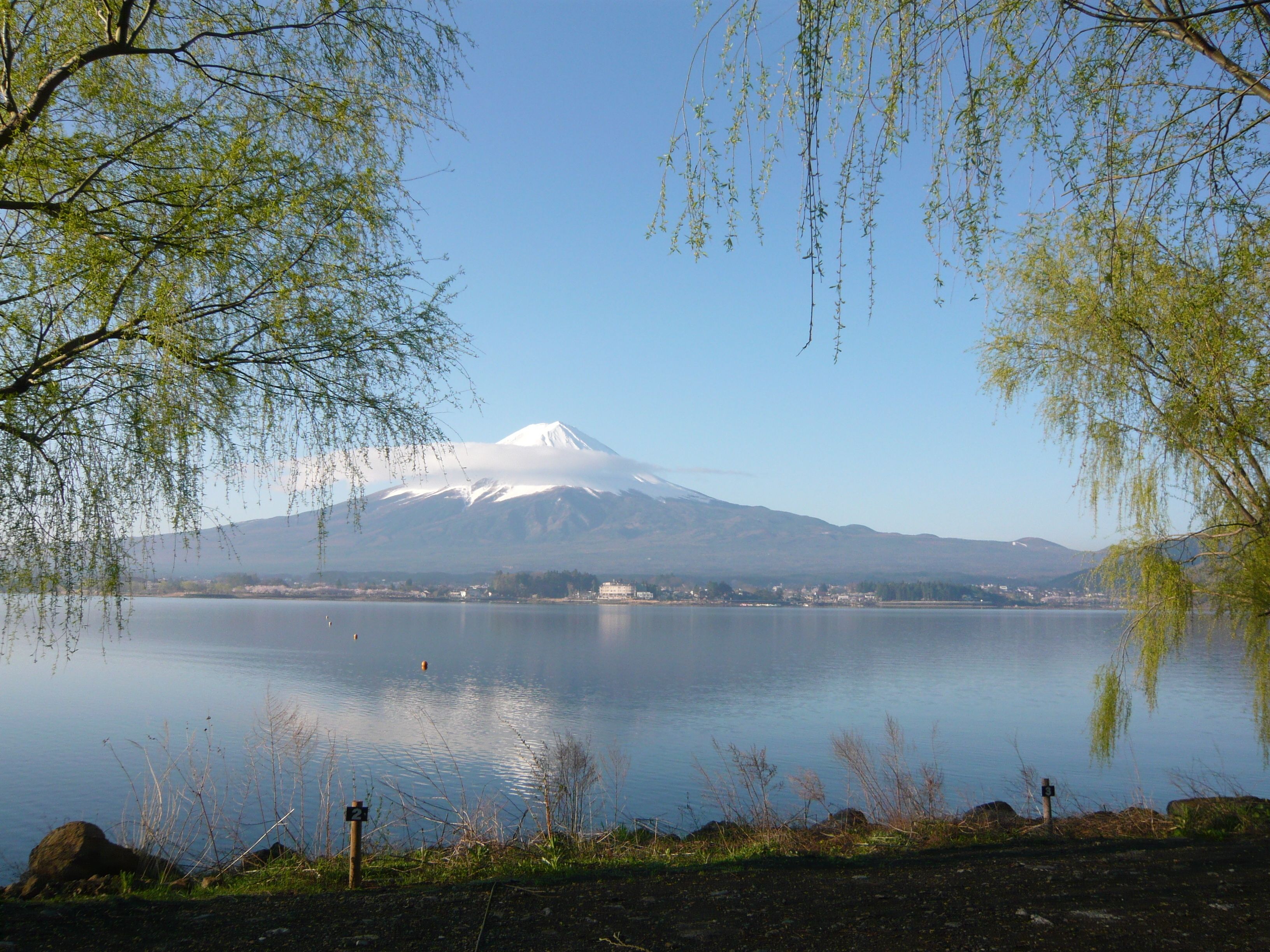 A calm lake with a mountain in the background.