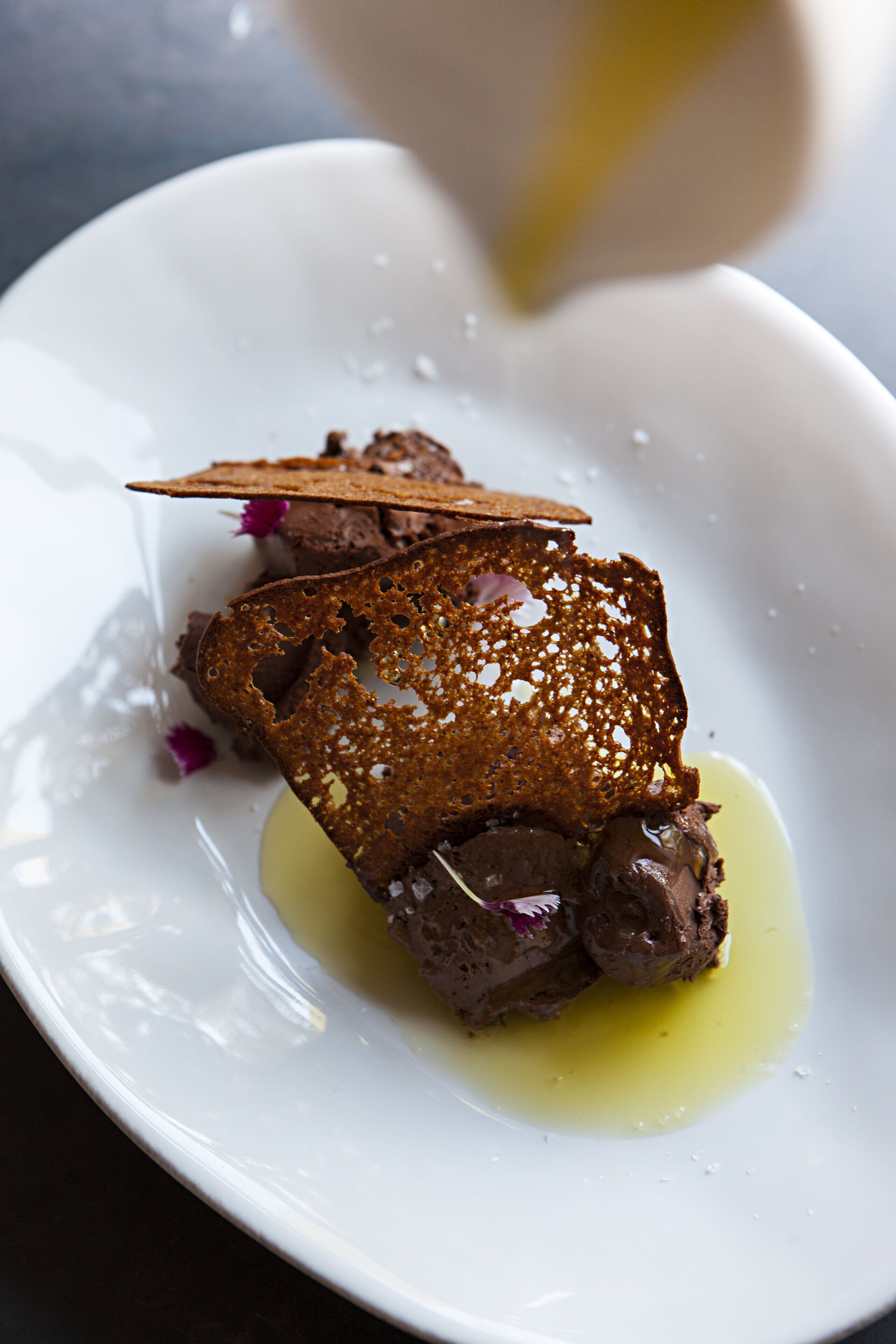 A dessert on a white plate with a drizzle of sauce.