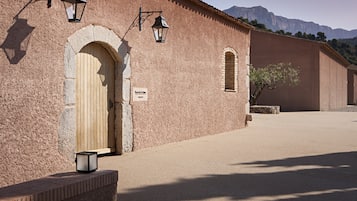 A building with a wooden door, a sign, and a lantern.