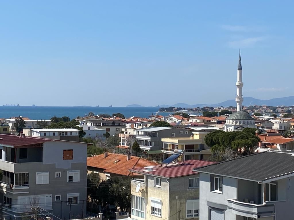 A coastal residential area with a prominent mosque and a dome structure.