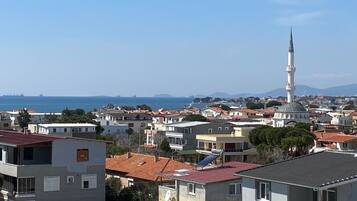 A coastal residential area with a prominent mosque and a dome structure.