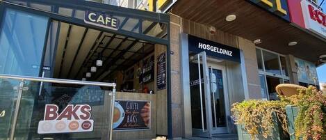 A building with a cafe, a hotel, and a bakery.
