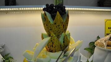 A fruit display with a banana, melon, and blueberries.
