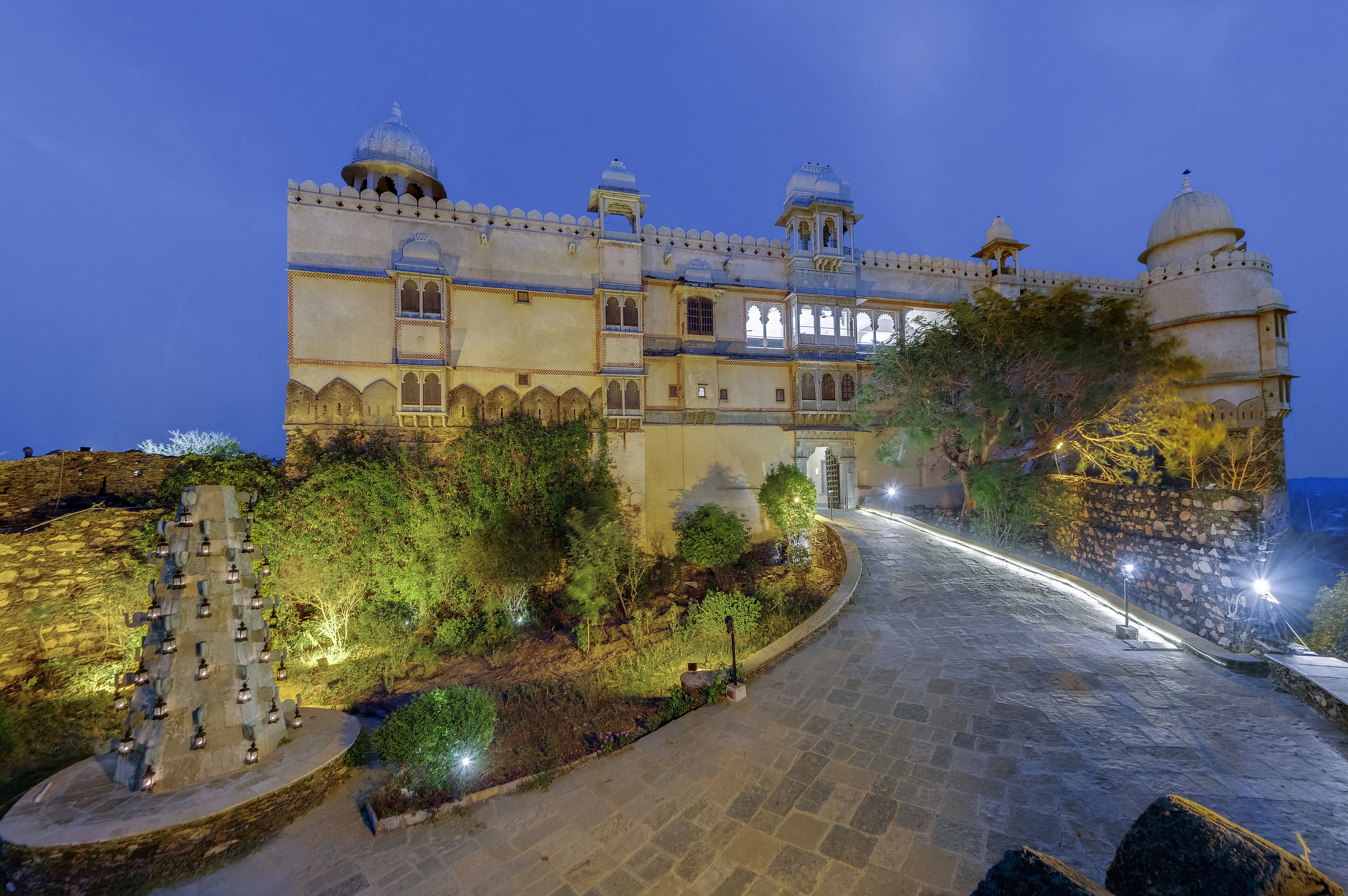 Un edificio histórico con un amplio patio central, sendero de piedra y arquitectura tradicional.
