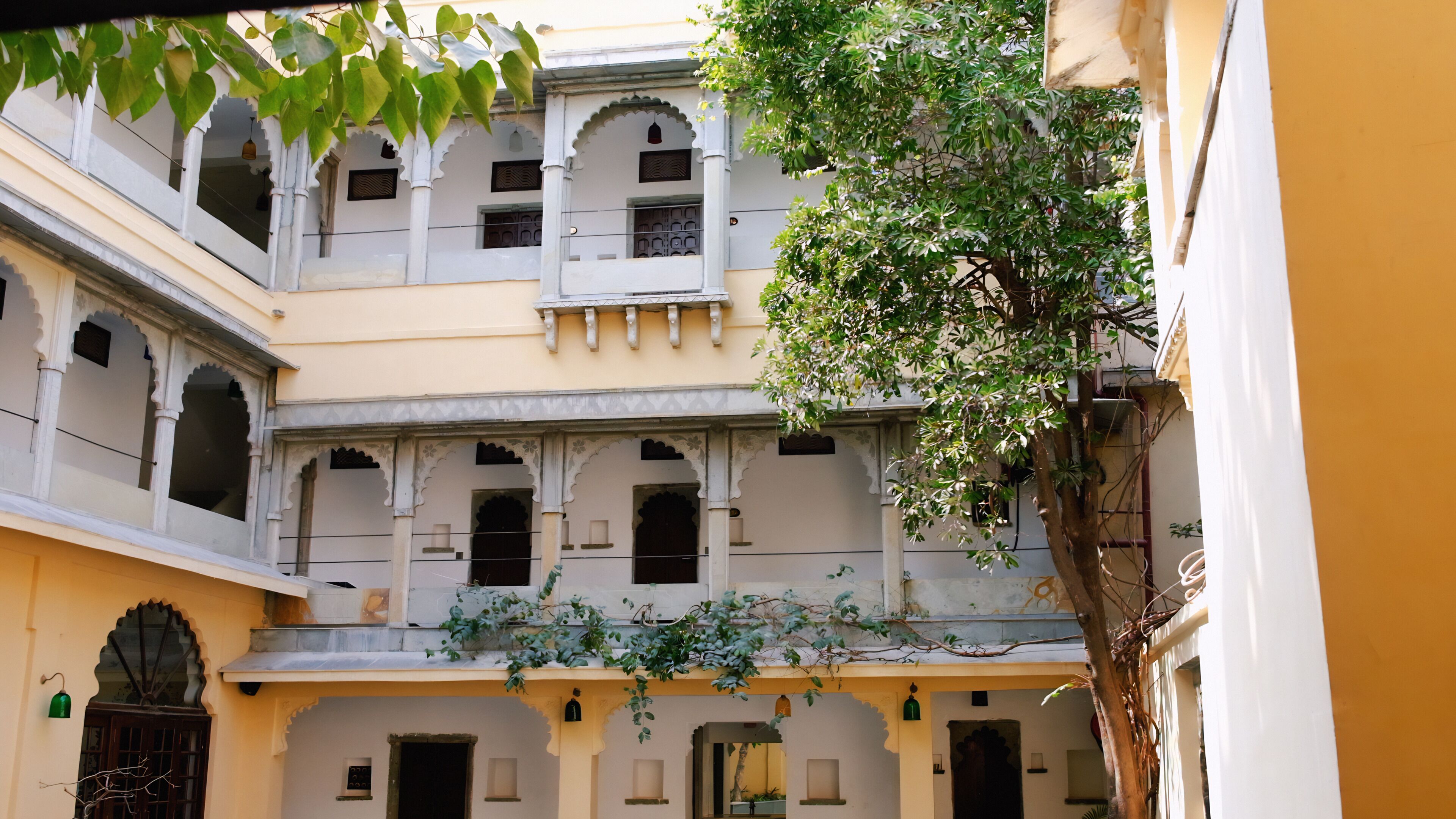 A multi-story building with traditional architecture, featuring arched windows and balconies.