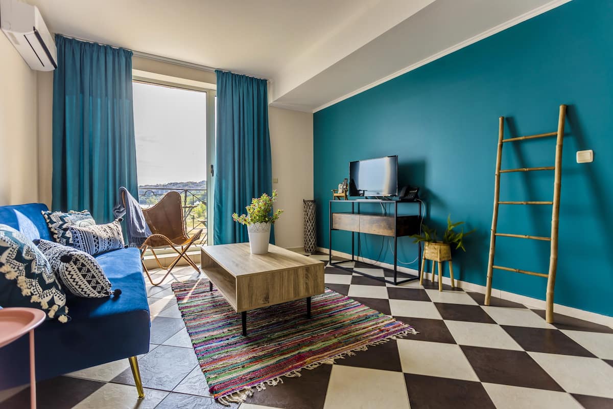 Deluxe Apartment, 1 Bedroom, Sea View | 1 bedroom, in-room safe, desk, blackout drapes
