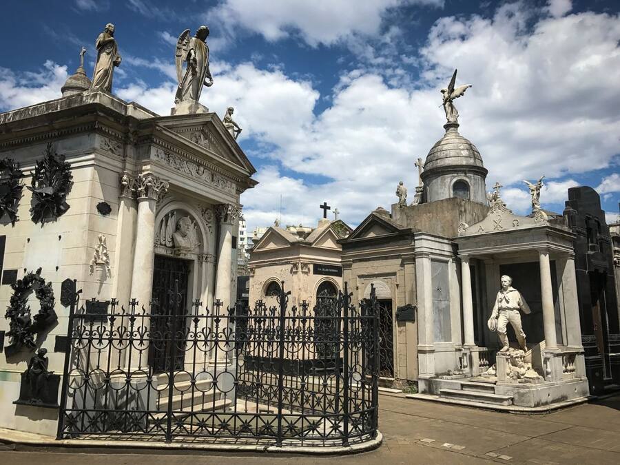A historical building with classical architecture, featuring statues, columns, and ornate decorations.